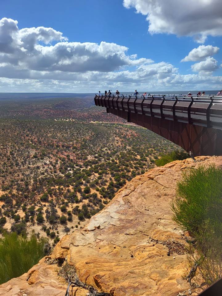 Kalbarri Skywalk juts over a vast rugged gorge while visitors admire the view.