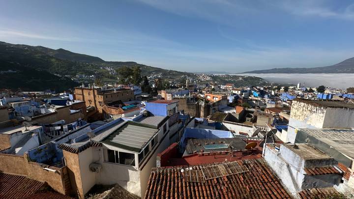 Panoramic view over blue-washed houses of Chefchaouen set among hills