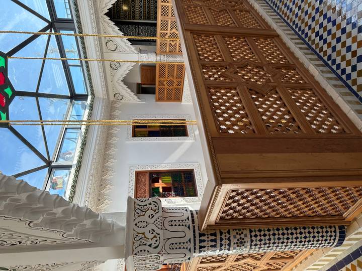 Elegant riad atrium with carved plaster, stained glass skylight and wooden balustrade
