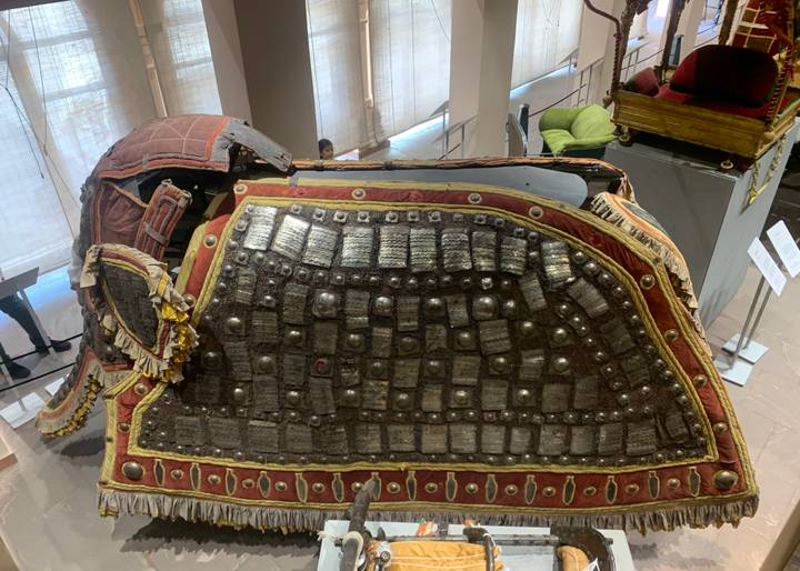Armoured elephant saddle on display inside palace museum hall