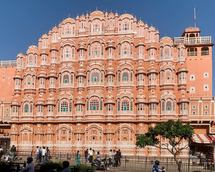 Façade of Jaipur's pink Hawa Mahal with countless latticed windows