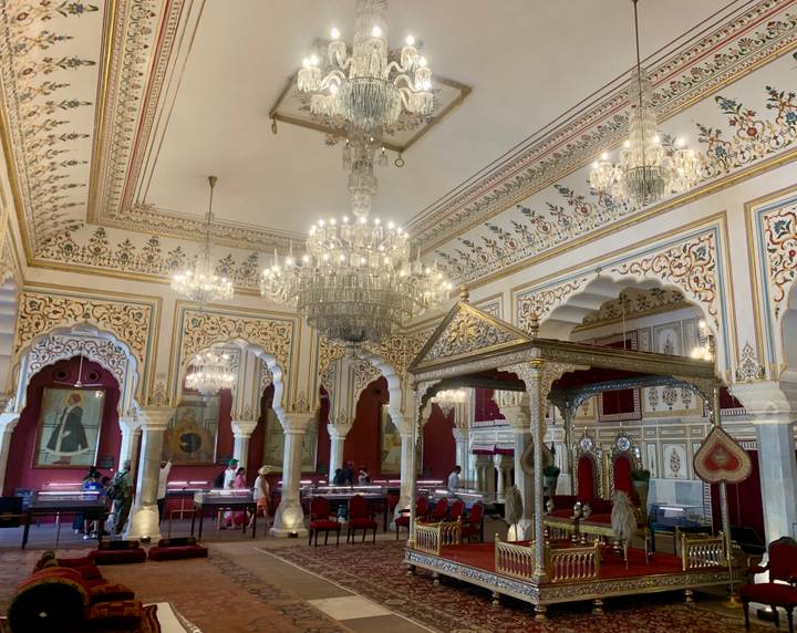 Lavish palace interior with chandeliers, painted ceilings and gold throne