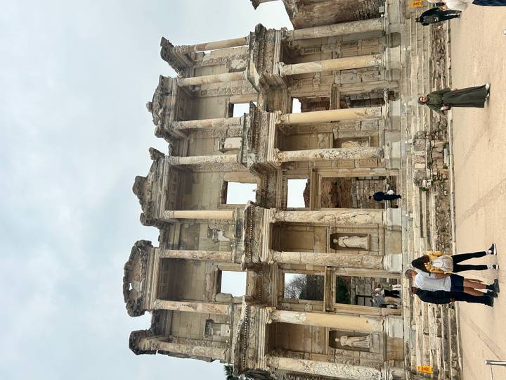 Ruins of the Library of Celsus with visitors exploring the ancient façade.
