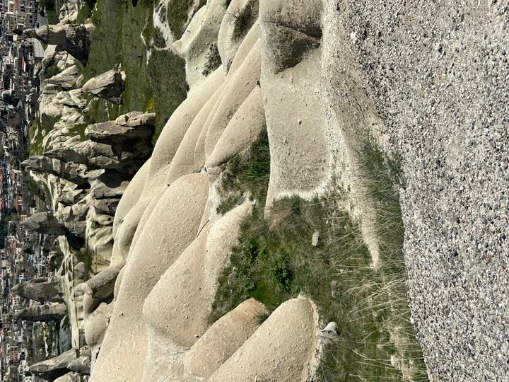Eroded beige rock formations and valleys typical of Cappadocia.