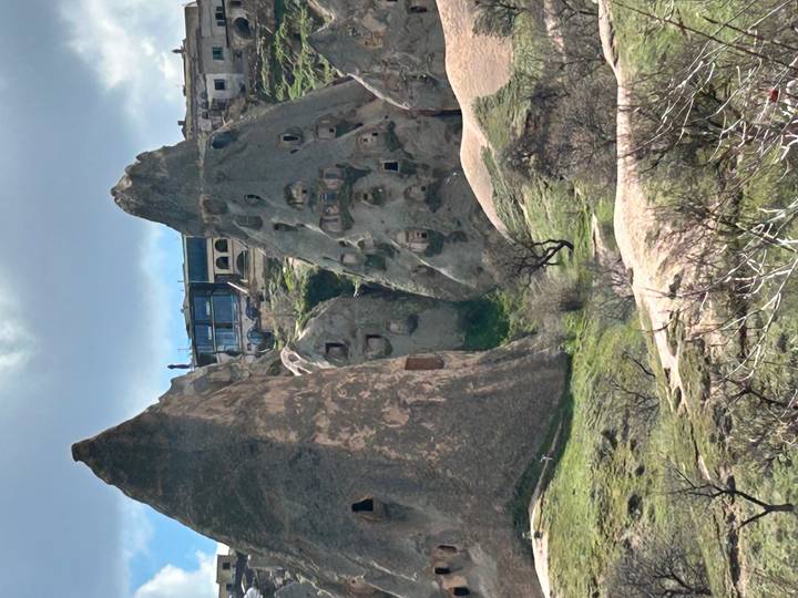 Tall fairy-chimney rock structures with ancient cave dwellings.