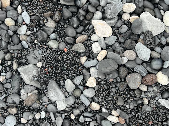 Close-up of smooth black and grey volcanic pebbles on Iceland’s south coast.