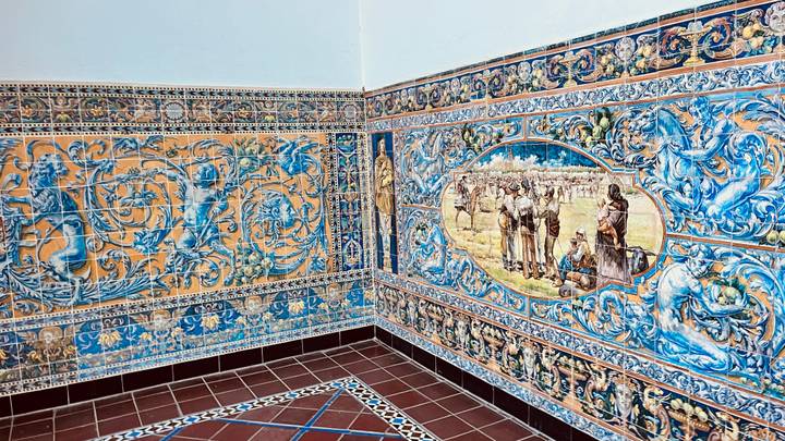 Brightly painted ceramic tile murals with intricate blue and yellow patterns on interior walls.