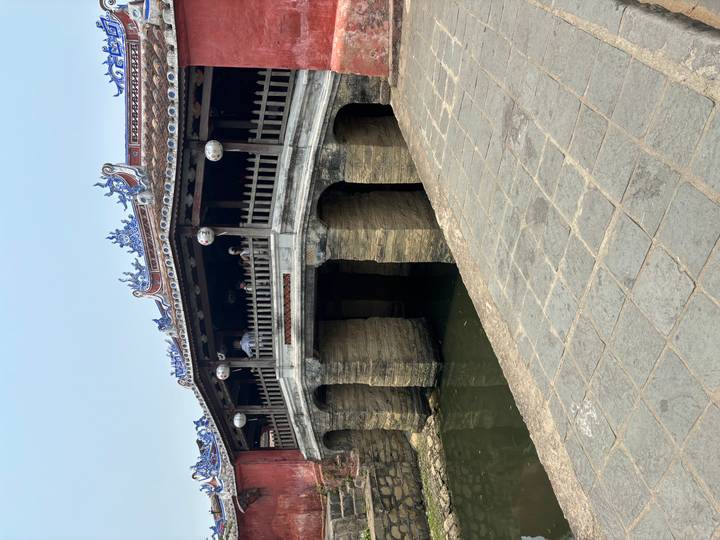 Historic Japanese Covered Bridge spans a narrow canal in Hoi An ancient town.