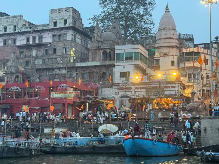 Evening rituals and crowded steps along the Ganges ghats in Varanasi lit by warm lights.