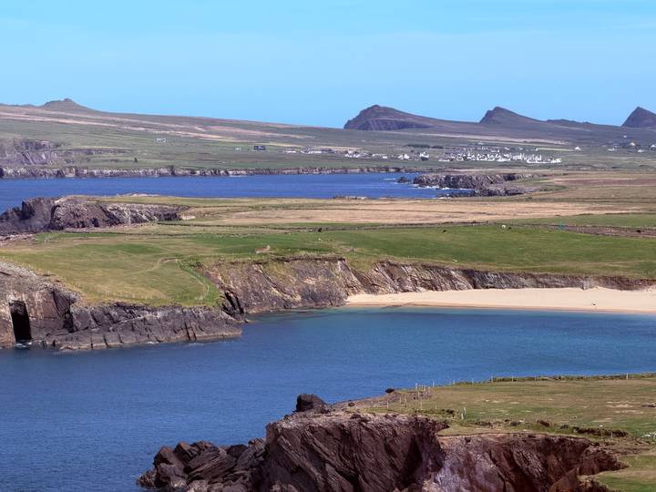 Turquoise bay, sandy beach and rugged headlands along the scenic Slea Head coastline.