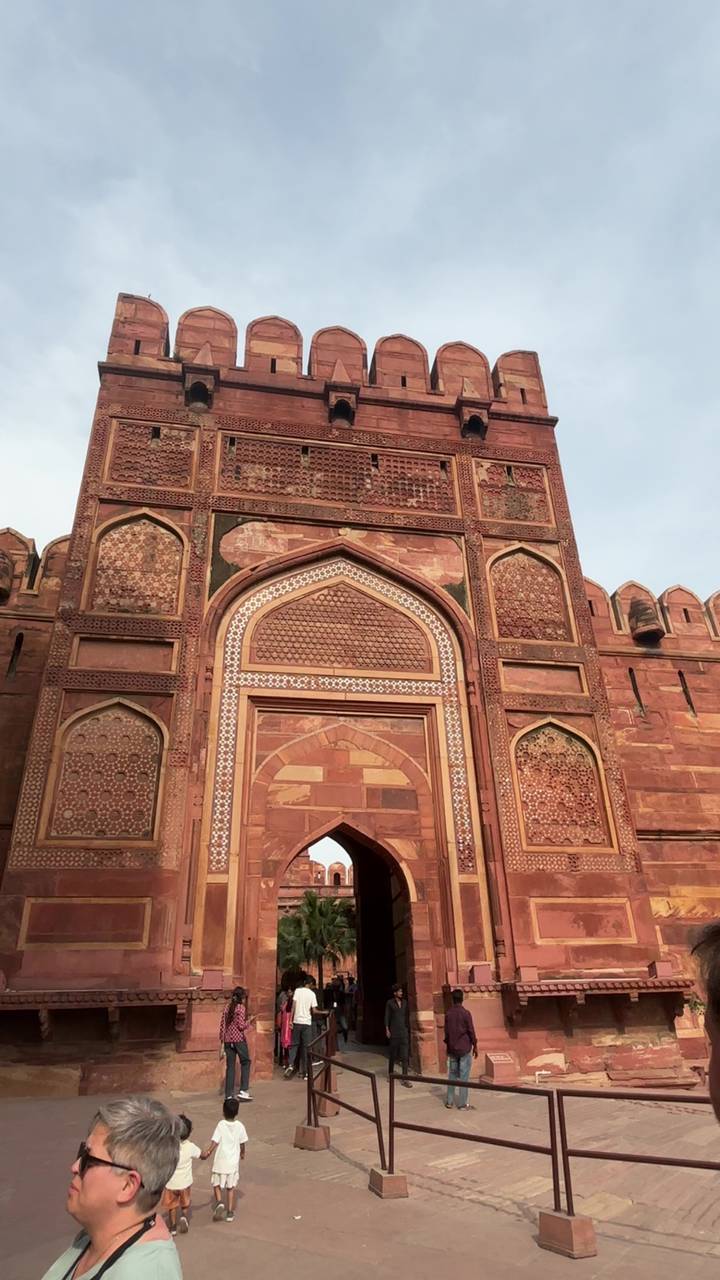 Close-up of ornate red sandstone gateway decorated with intricate inlay work at Agra Fort.