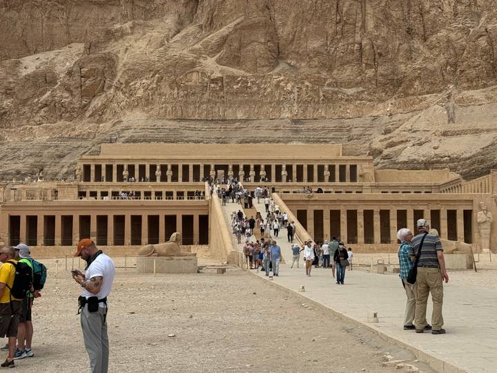 Visitors ascend the grand ramps of Hatshepsut’s Mortuary Temple carved into the cliffs at Deir el-Bahari.