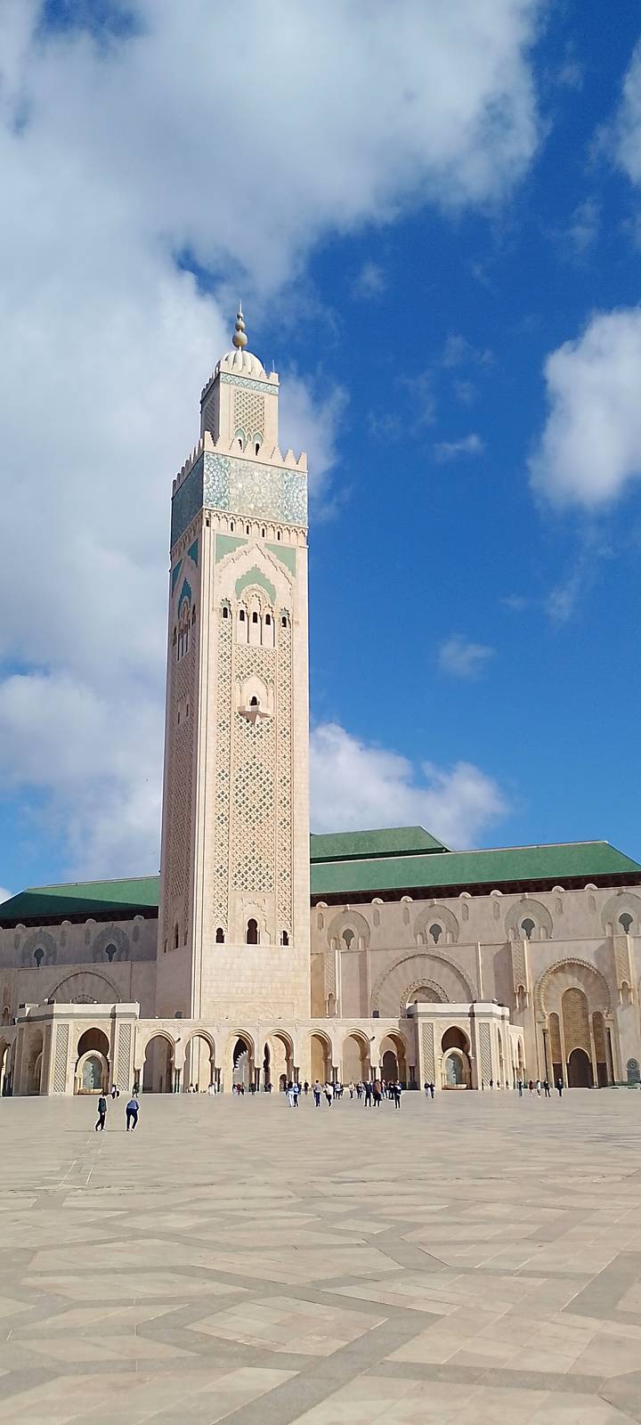 Elegant minaret of Hassan II Mosque rising into a clear blue sky