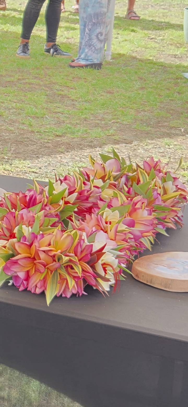 Colorful close-up of freshly woven flower leis on a table