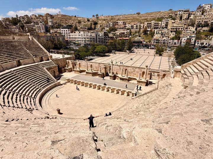 Sweeping view across the stone seating of Amman’s Roman Theater toward the modern city below.