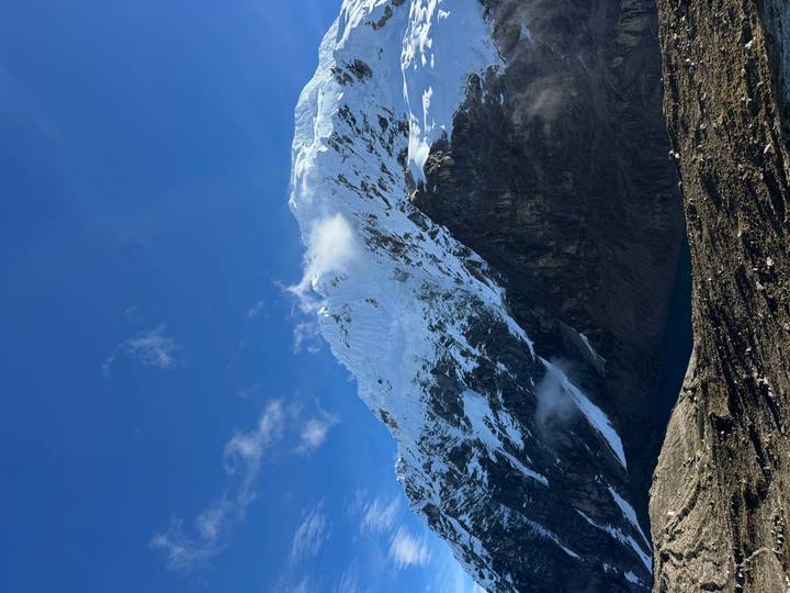 Towering snow-capped Andean peak rising into a clear blue sky.