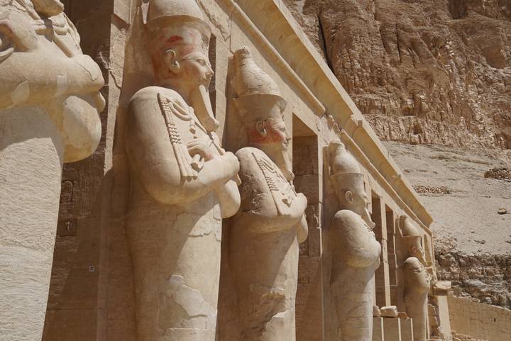 Row of colossal Osirid statues lining the façade of Hatshepsut’s mortuary temple.