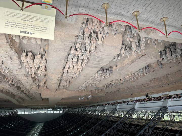 Expansive view of Terracotta Army excavation pit with rows of ancient clay soldiers