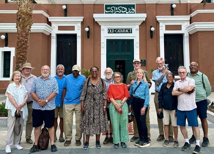 Group tour portrait in front of Old Cataract Hotel entrance in Aswan, Egypt.
