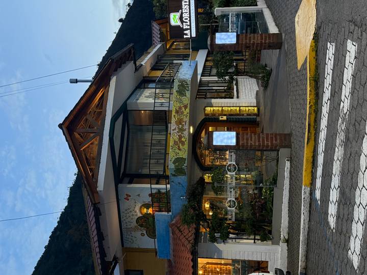 Charming two-story inn with painted exterior and warm evening lights on a quiet street.