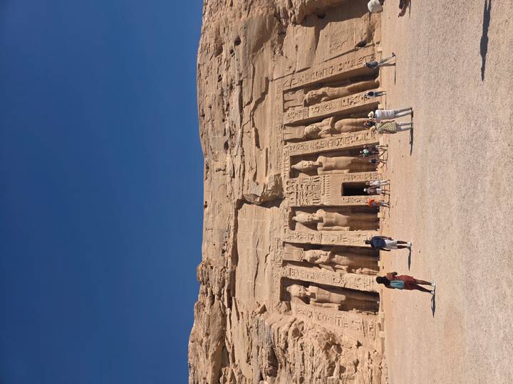 Tourists walking in front of the Small Temple at Abu Simbel with statues of Ramesses and Nefertari.