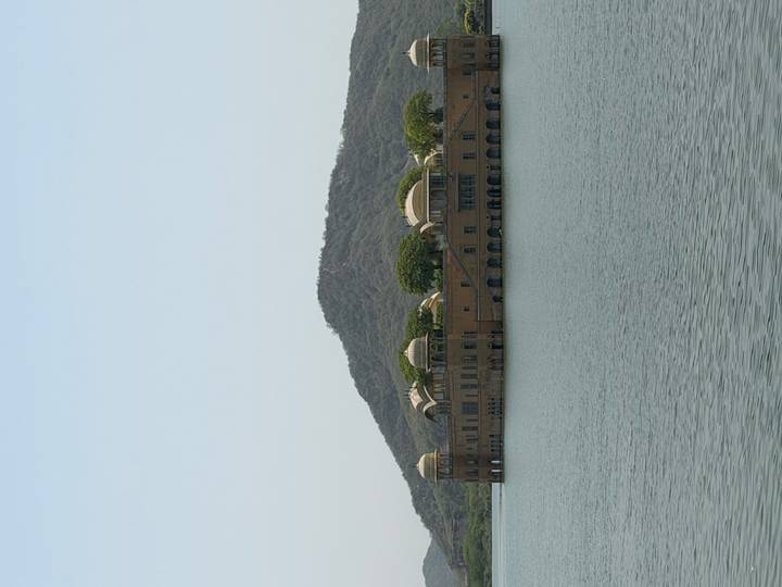 Jal Mahal palace sits serenely in the middle of Man Sagar Lake against a wooded hill backdrop.