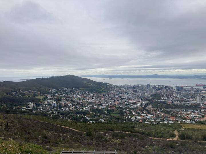 Wide view across Cape Town neighborhoods towards Table Bay under gray skies
