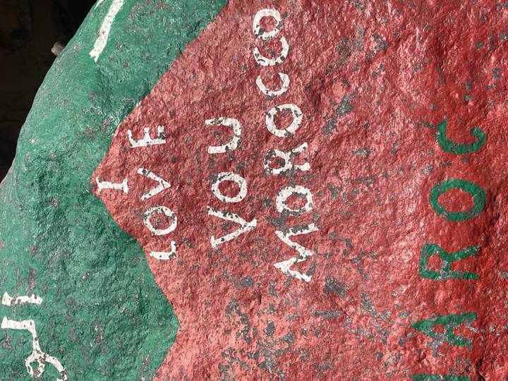 Painted red and green rock bearing the words “I LOVE YOU MOROCCO.”