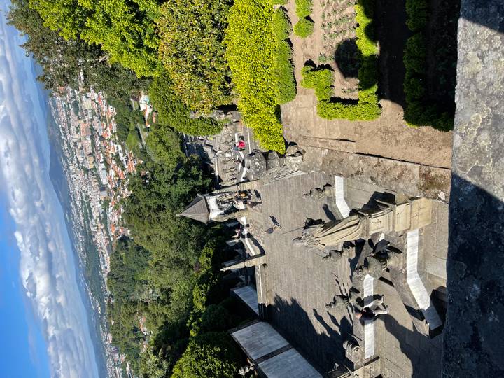 Baroque staircase of Bom Jesus do Monte descending toward panoramic views of Braga city below.