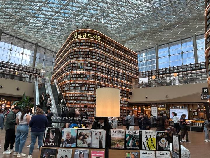Interior of Starfield Library with towering book shelves and busy visitors