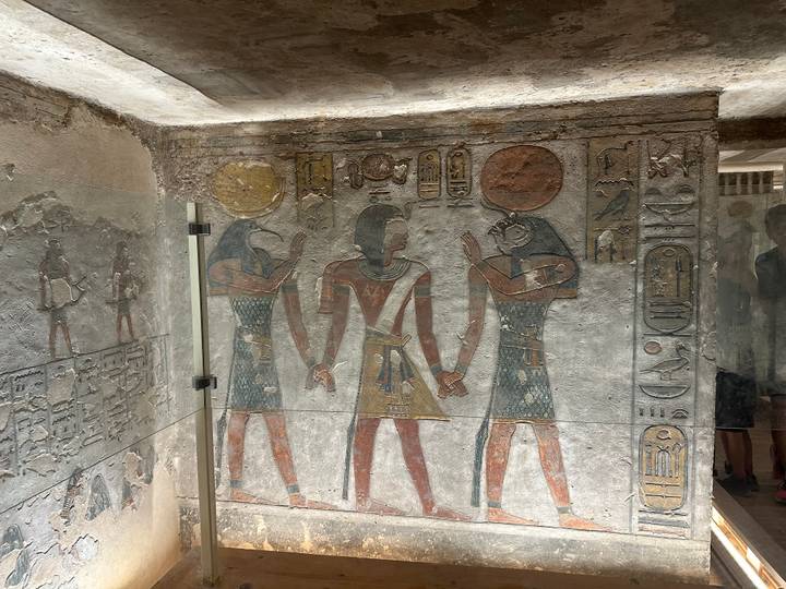 Intricately painted figures and hieroglyphs on the walls of a tomb in the Valley of the Kings.