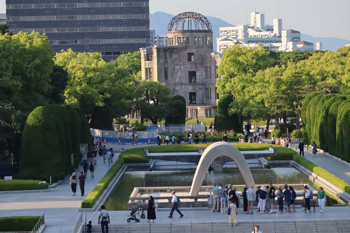 View across Hiroshima Peace Memorial Park with the A-Bomb Dome framed by greenery