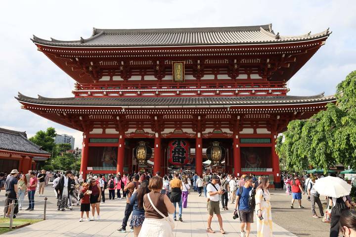 Grand red entrance gate of Senso-ji Temple bustling with crowds of visitors