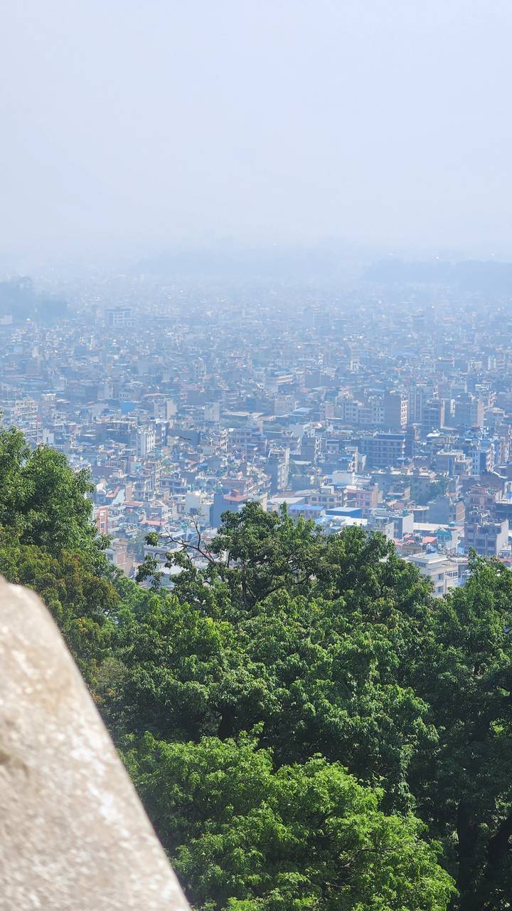 Densely packed urban skyline of Kathmandu valley viewed through light haze
