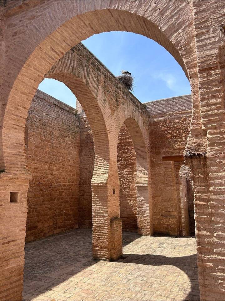 High sandstone arches and textured brick walls of an ancient Moroccan structure