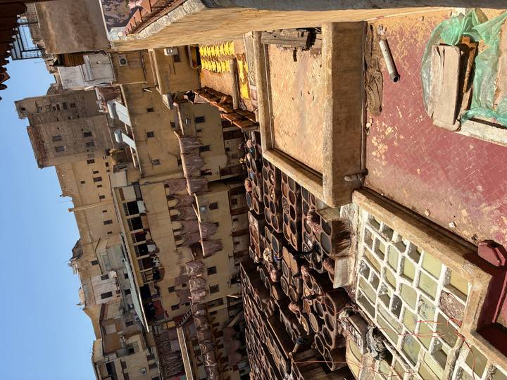 Panoramic view of Fes leather tannery with rows of dyeing pits and surrounding ochre buildings