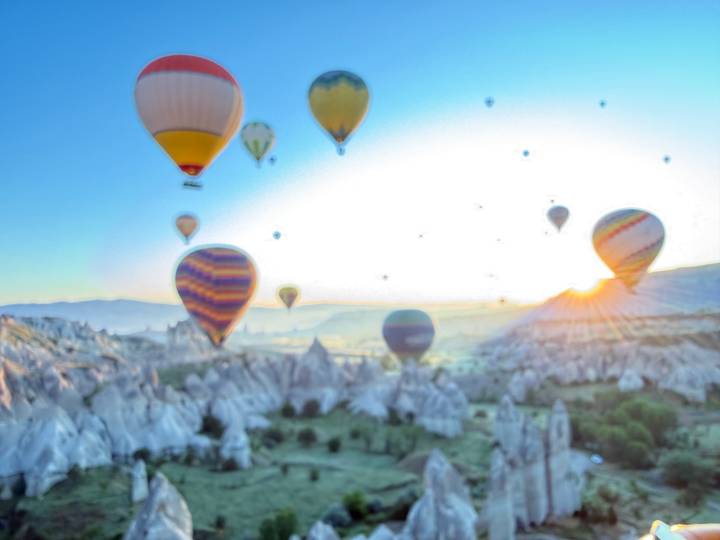 Duplicate blurry image of Cappadocia balloons at sunrise.