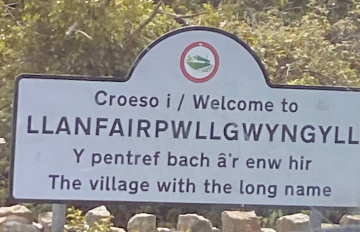 Welcome sign to the famously long-named Welsh village Llanfairpwllgwyngyll.