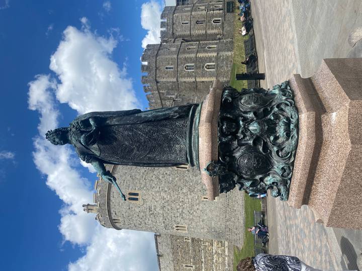 Bronze statue of Queen Victoria with Windsor Castle’s Round Tower in background.