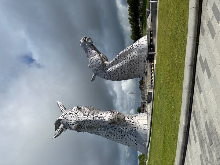 The colossal steel horse-head sculptures known as The Kelpies against a stormy sky.