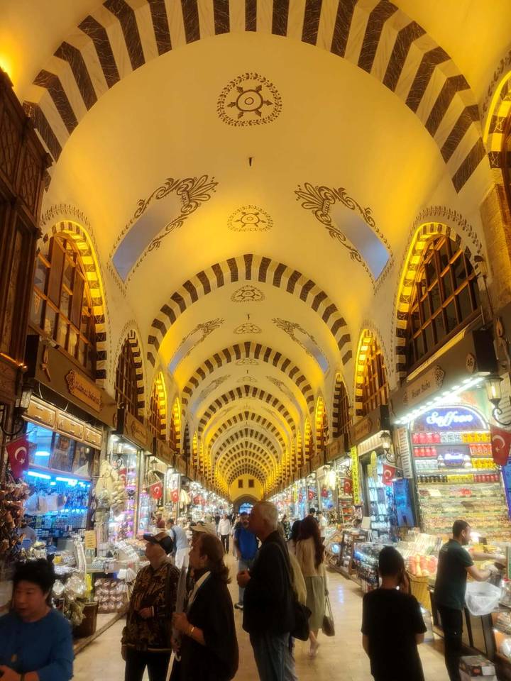 Illuminated arched ceiling of Istanbul's Spice Bazaar with golden lighting