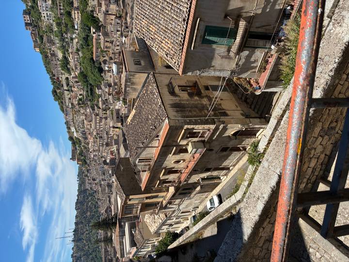 Panoramic view across the steep stone lanes and terracotta roofs of Modica’s old town