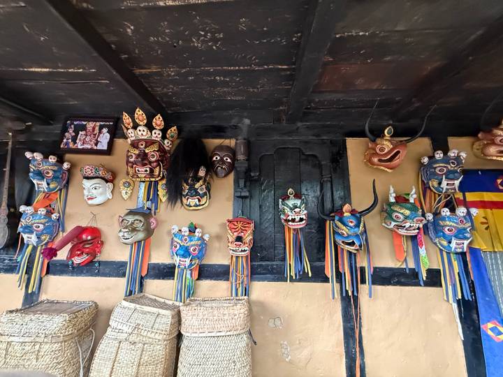 Colorful traditional Bhutanese festival masks hanging on a wooden interior wall