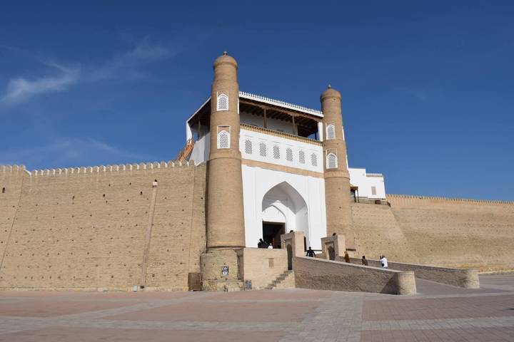 Ark fortress gatehouse in Bukhara with blue sky backdrop and expansive plaza