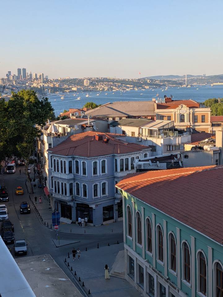 Elevated view of colorful Ottoman houses and rooftops overlooking the Bosporus and distant boats