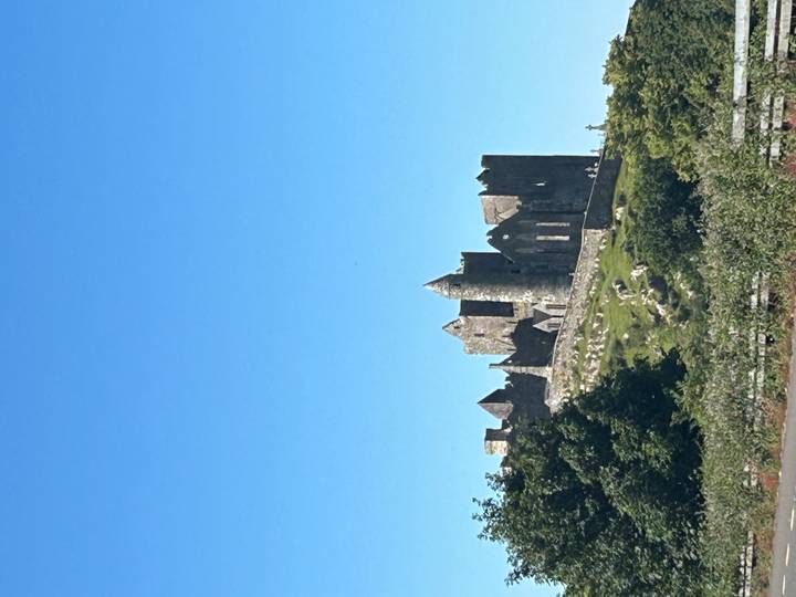 The medieval Rock of Cashel perched on a green hill beneath a clear Irish sky
