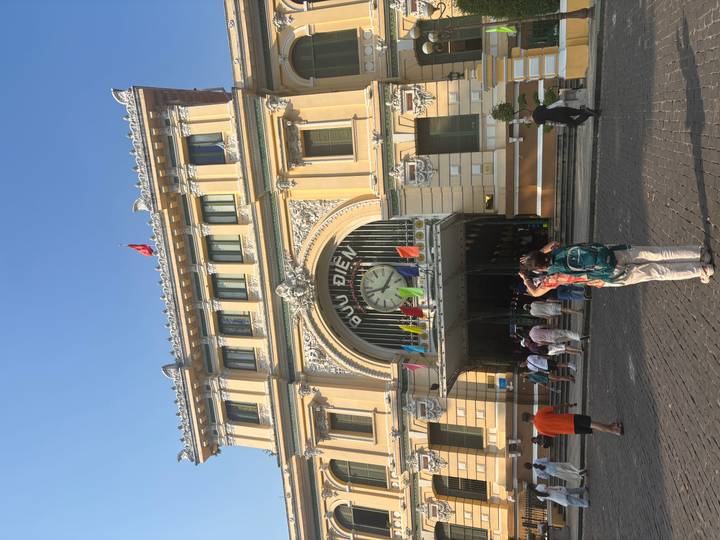 Tourists photograph the ornate façade and clock of Saigon’s Central Post Office.