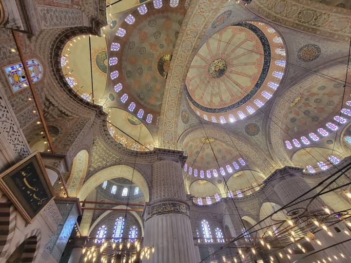 Ornate interior domes of the Blue Mosque showcase intricate patterns and glowing windows.