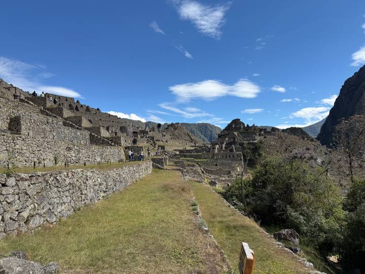 Repeat panoramic scene of Machu Picchu ruins beneath a brilliant Andean sky.