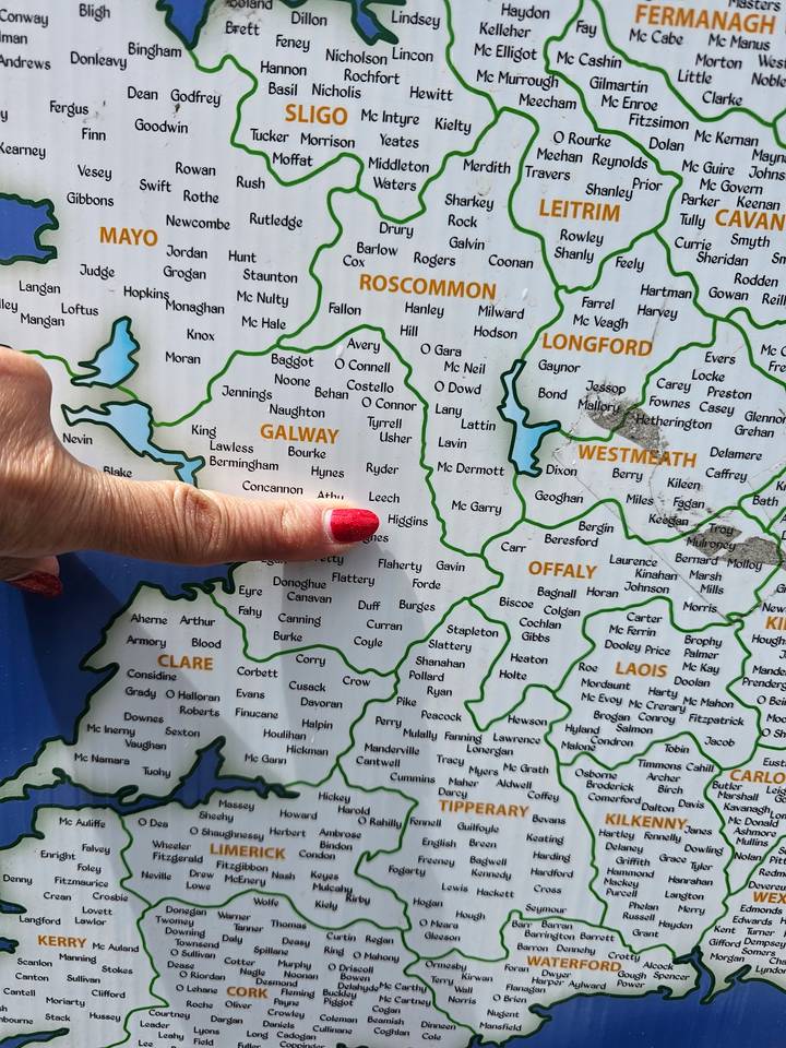 Close-up of a travel map of Ireland with a hand pointing to Galway county